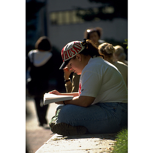 student sits while reading book