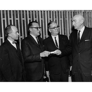 Professor Robinson, President Knowles, and William Alexander stand with another man