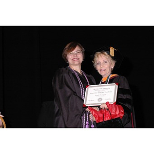 Carole Kenner presents Pamela D. Gorgone with an award at the School of Nursing convocation ceremony