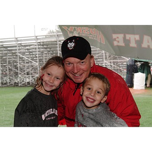 Three Northeastern fans pose before the Homecoming game