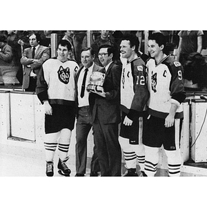 Head Coach Fern Flaman and the men's hockey tri-captains