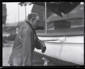 John P. Johnson ("Armless Johnson"), painting a boat