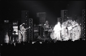 Grateful Dead concert at Springfield Civic Center: band in performance in front of a wall of speakers (spotlight on Bob Weir and Jerry Garcia)