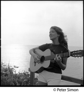 Lucy Simon, playing guitar by the sea