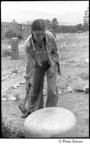Young woman ringing a dome-shaped gong, Lama Foundation