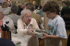 Church supper at the First Congregational Church, Whately: young boy busing tables