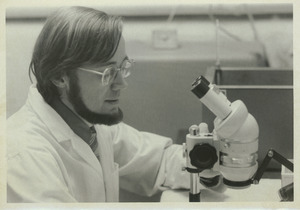 Henry Howard Hagedorn sitting in front of a microscope