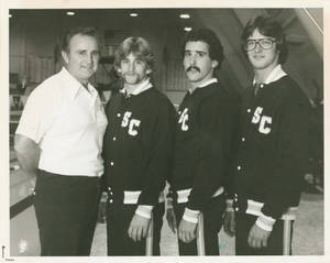 Coach Charles J. Smith with three SC Swimmers