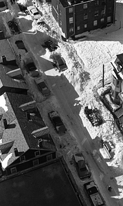 Aerial view of street and cars buried in snow