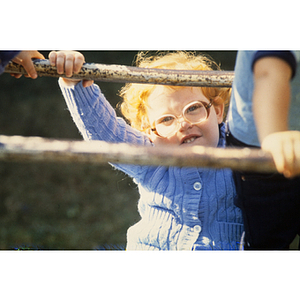 Child hanging on monkey bars