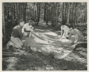 Campers putting up a tent