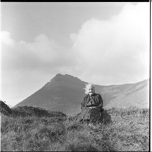 Mrs. O'Reilly sitting in a field surrounded by the Mourne Mountains, Annalong, Co. Down