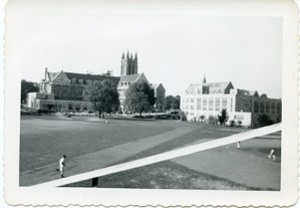Alumni Field and stands with view of Gasson Hall, Devlin Hall, and other campus buildings