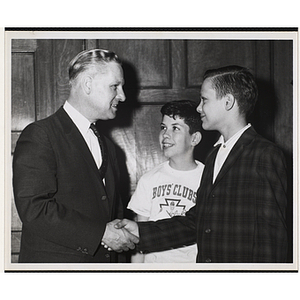 William J. Lynch shaking hands with a boy as another looks on at the Youth of the Year celebration