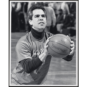 Veteran Boston meteorologist Harvey Leonard preparing to shoot a basketball at a fund-raising event held by the Boys and Girls Clubs of Boston and Boston Celtics