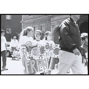 Two girls and a boy marching with a banner reading "FRIENDSHIP" during the Boys and Girls Clubs of Boston 100th Anniversary Celebration Parade