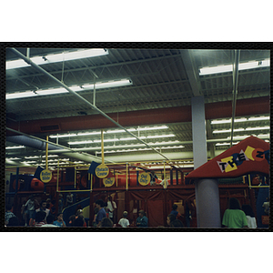 Children play under the supervision of adults in a Chuck E. Cheese's playground
