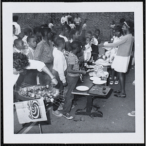 Boys wait on line at a cookout