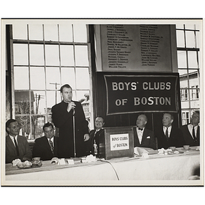 A priest speaking at the head table during a Boys' Clubs of Boston awards event