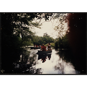 A girl and a supervisor paddle a canoe