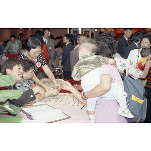 Guests at the welcome table for the Chinese Progressive Association's 15th Anniversary Celebration