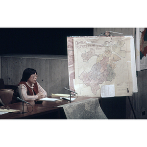 Woman speaks to City Council members concerning district representation in Boston