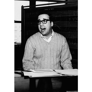 Associate Professor Michael L. Woodnick singing while playing the piano