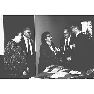 Five people converse indoors at the Snell Library dedication