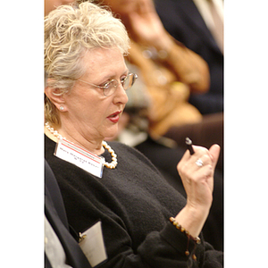 Mary Margaret Baker, '72, taking notes at the NU Today cancer research panel