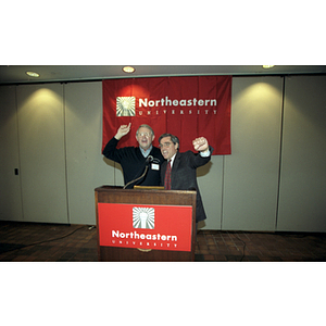 President Freeland and Chairman of the Board Neal Finnegan stand at a podium