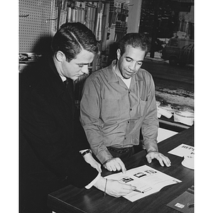 Business administration co-op student Keith Walker, left, discusses a sales promotion with a hardware store owner