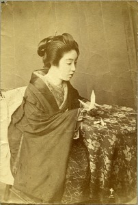 Japanese woman holding origami crane