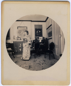 Abby F. Blanchard in the parlor, with parasol and kimono