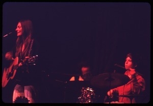 Judy Collins: performing on stage with drummer Susan Evans and keyboardist Michael Sahl (tinted red)
