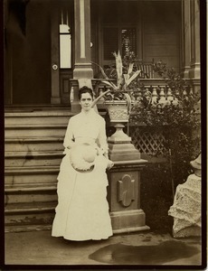 Mary Sanger Lyman: wedding portrait standing beside house
