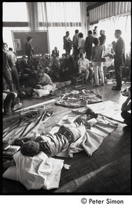 Students sleeping on the floor and milling about the Sala de Puerto Rico : Vietnam War sanctuary at MIT