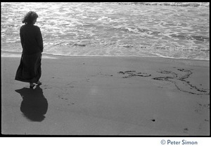 Usha (Cathy Brown) silhouetted against the bright light on the beach