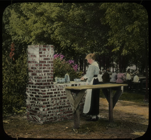 Camp fireplace, Topeka (woman cooking on brick stove)