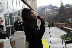 Justice for Jason rally at UMass Amherst: speaker on the south deck of the Student Union building at the rally in support of Jason Vassell