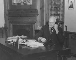 Ralph A. Van Meter using phone at desk