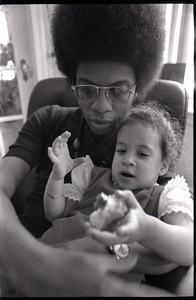 Herbie Hancock feeding daughter Jessica in lap - Digital Commonwealth