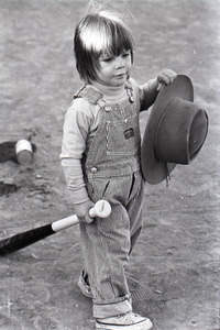 Boston Phoenix vs. WBCN staff softball game: child with hat and softball bat