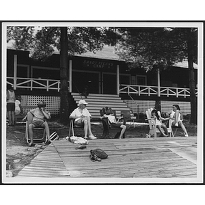 Children and adults sitting in lawn chairs at Sandy Island Camp