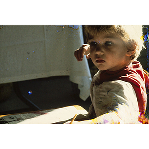 Child drawing with yellow pencil