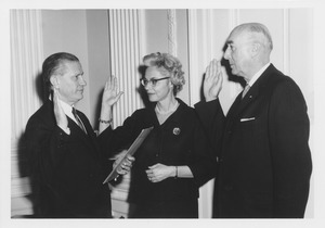 Carolyn C. Rowland and John J. Maginnis being sworn in as trustees by an unidentified man
