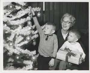 Anne Guin and children decorating Christmas tree