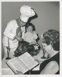 Chef Michael Malone and Leslee Trimble with turkey and woman reading bible