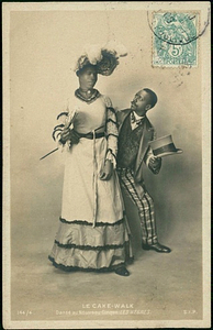 Jack Brown Poses in Drag in Front of Dance Partner Charles Gregory, Holding a Fan