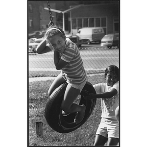 Children playing with tire swing
