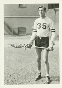 Vernon Cox holding a lacrosse stick (ca. 1942)